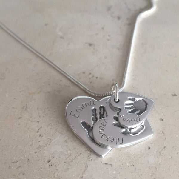 Cascading heart pendants hand print