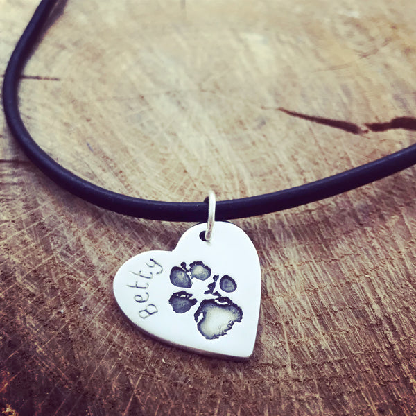 paw print on a leather necklace