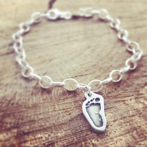 shaped foot print charm on a belcher bracelet