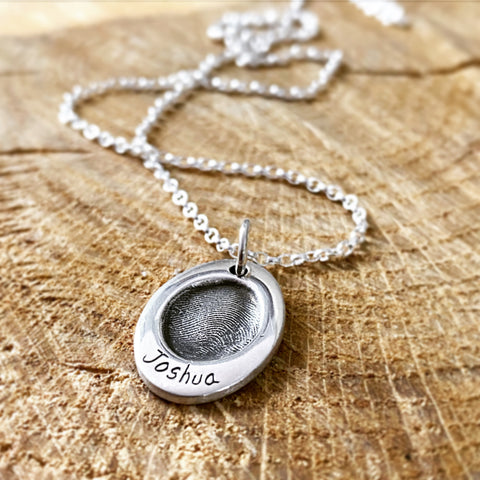 fingerprint oval pendant on a necklace