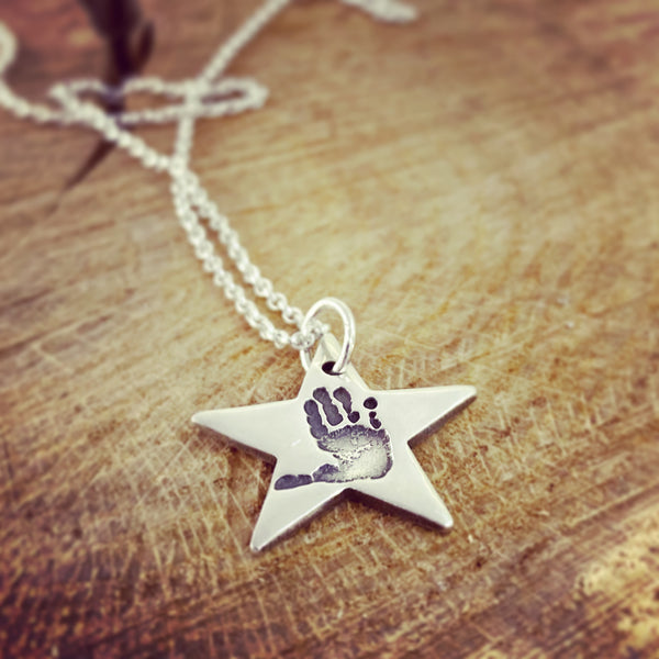 handprint star pendant on a belcher necklace