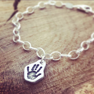 hand print shaped charm on a belcher bracelet