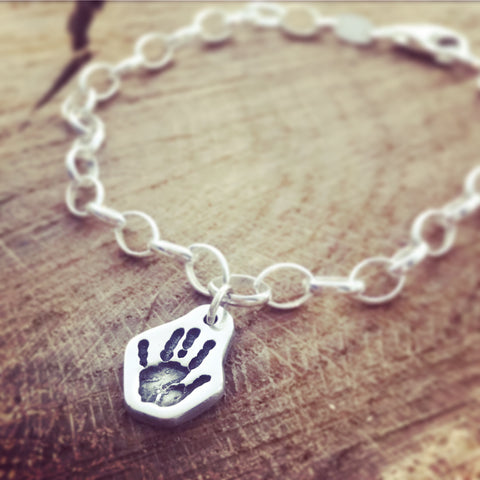 hand print shaped charm on a belcher bracelet
